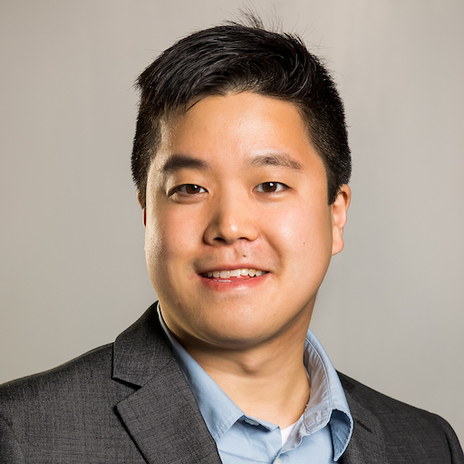 Leyan Lo, smiling in a blue shirt and gray suit